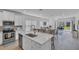 Open-concept kitchen with a large island, modern stainless steel appliances, and a seamless flow into the living area at 7412 Sw 76Th Ter, Ocala, FL 34481