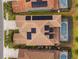 Aerial shot of roof with solar panels and pool with screened enclosure at 7630 Oakmoss Loop, Davenport, FL 33837
