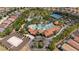 Aerial view of beautiful clubhouse, pool, palms, volleyball court and community homes in landscaped neighborhood at 7630 Oakmoss Loop, Davenport, FL 33837