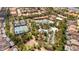 A high angle view shows a large, community tennis court near parking area and lazy river with winding water features at 7630 Oakmoss Loop, Davenport, FL 33837