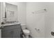 Well-lit bathroom with granite vanity, toilet, and a chrome towel bar at 7630 Oakmoss Loop, Davenport, FL 33837