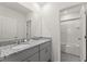 Bright bathroom with double sinks and a shower at 7630 Oakmoss Loop, Davenport, FL 33837