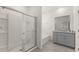 The bathroom has a walk-in shower, bathtub, vanity, and tile flooring at 7630 Oakmoss Loop, Davenport, FL 33837