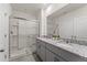 Bathroom featuring double sinks, granite countertops, and a large glass shower at 7630 Oakmoss Loop, Davenport, FL 33837