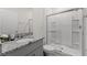 Bright bathroom featuring a granite vanity top and a glass-enclosed shower at 7630 Oakmoss Loop, Davenport, FL 33837