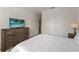 Comfortable bedroom featuring a wooden dresser with TV and a closet with bi-fold doors at 7630 Oakmoss Loop, Davenport, FL 33837