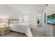 Neutral colored bedroom with carpet, an ensuite bathroom, and a flatscreen television at 7630 Oakmoss Loop, Davenport, FL 33837
