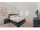 The spacious bedroom has soft carpet, natural light, and access to a bathroom at 7630 Oakmoss Loop, Davenport, FL 33837