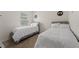 Bright bedroom featuring two beds with white linens, neutral carpet, and natural light at 7630 Oakmoss Loop, Davenport, FL 33837