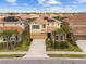 Stunning two-story home boasts well-manicured landscaping, tile roof, and solar panels for energy efficiency at 7630 Oakmoss Loop, Davenport, FL 33837