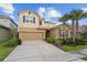 Inviting two-story home with lush landscaping, tile roof, and a two-car garage at 7630 Oakmoss Loop, Davenport, FL 33837