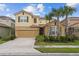 Charming two-story home with lush landscaping and a two-car garage at 7630 Oakmoss Loop, Davenport, FL 33837