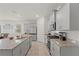 Modern kitchen featuring granite countertops, stainless steel appliances, and an open-concept design at 7630 Oakmoss Loop, Davenport, FL 33837