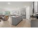 Modern kitchen featuring stainless steel appliances, granite countertops, and a large center island with seating at 7630 Oakmoss Loop, Davenport, FL 33837