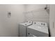 Bright laundry room featuring a Whirlpool washer and dryer, and wire shelving at 7630 Oakmoss Loop, Davenport, FL 33837