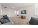 Bright living room featuring sofas and entertainment center at 7630 Oakmoss Loop, Davenport, FL 33837