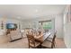 Open-concept living and dining area featuring a large table and sliding glass doors to the pool at 7630 Oakmoss Loop, Davenport, FL 33837