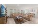 Spacious living room featuring a plush sectional sofa, rustic coffee table, and a large TV at 7630 Oakmoss Loop, Davenport, FL 33837