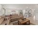 Open floor plan with spacious living area, kitchen island with barstools, and dining area with sliding glass doors at 7630 Oakmoss Loop, Davenport, FL 33837