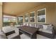 Covered patio with comfortable outdoor furniture and view of the backyard at 7630 Oakmoss Loop, Davenport, FL 33837