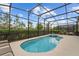 This screened-in pool and spa is an oasis for relaxation, with lounge chairs at 7630 Oakmoss Loop, Davenport, FL 33837