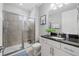 Well-lit bathroom with a glass-enclosed shower, modern vanity, and stylish fixtures at 7702 Fairfax Dr, Kissimmee, FL 34747