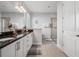 Stylish bathroom with a walk-in shower, granite countertops, white cabinets, and modern fixtures at 7702 Fairfax Dr, Kissimmee, FL 34747