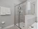Modern bathroom featuring a glass-enclosed shower, neutral tones, and sleek design at 7702 Fairfax Dr, Kissimmee, FL 34747