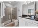 Bathroom featuring a glass door shower, white cabinets, and granite countertop at 7702 Fairfax Dr, Kissimmee, FL 34747