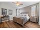 Bedroom with a wooden bed, two windows, and a small desk area at 7702 Fairfax Dr, Kissimmee, FL 34747