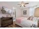 Charming bedroom features a ceiling fan and a large television for relaxing entertainment at 7702 Fairfax Dr, Kissimmee, FL 34747