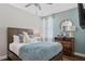 Stylish bedroom showcases a cozy bed with plush bedding and comforting natural light at 7702 Fairfax Dr, Kissimmee, FL 34747