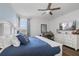Bedroom with blue comforter, and a view of the office area on the right at 7702 Fairfax Dr, Kissimmee, FL 34747