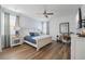 Bedroom with a bed, a desk with a chair, and wooden floors at 7702 Fairfax Dr, Kissimmee, FL 34747