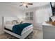 Bright bedroom features a ceiling fan, natural light, white furnishings, and cozy decor, creating a serene and inviting atmosphere at 7702 Fairfax Dr, Kissimmee, FL 34747