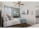 Serene bedroom featuring a TV, soft blue accent wall, and cozy window sunlight at 7702 Fairfax Dr, Kissimmee, FL 34747