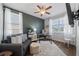 Bright home office featuring a comfy sofa, modern desk setup, and plenty of natural light at 7702 Fairfax Dr, Kissimmee, FL 34747