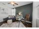Cozy home office with modern furniture, stylish decor, and ample natural light at 7702 Fairfax Dr, Kissimmee, FL 34747