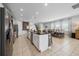 Open-concept kitchen boasts a large island with modern appliances and neutral countertops at 7702 Fairfax Dr, Kissimmee, FL 34747
