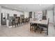 Bright and airy kitchen featuring granite counters, a center island, modern appliances, and an adjacent dining area at 7702 Fairfax Dr, Kissimmee, FL 34747