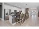 Bright kitchen features stainless steel appliances, granite counters, tile floors, and a breakfast bar with seating at 7702 Fairfax Dr, Kissimmee, FL 34747