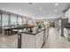 Bright, open kitchen with large island, stainless appliances, and seamless flow to dining and living areas at 7702 Fairfax Dr, Kissimmee, FL 34747