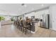 The kitchen island has barstool seating, white cabinetry, stainless steel refrigerator, and mosaic backsplash at 7702 Fairfax Dr, Kissimmee, FL 34747