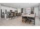 Open-concept kitchen with white cabinets, granite countertops, stainless steel appliances, and an adjacent dining area at 7702 Fairfax Dr, Kissimmee, FL 34747