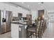 Modern kitchen featuring stainless steel appliances, granite countertops, a large island with seating, and white cabinetry at 7702 Fairfax Dr, Kissimmee, FL 34747