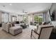 Bright living room with tile floors, a ceiling fan, and sliding doors to the outdoors at 7702 Fairfax Dr, Kissimmee, FL 34747