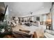 Bright living room boasts an open floor plan, tile floors, and a cozy seating area with a large sectional sofa at 7702 Fairfax Dr, Kissimmee, FL 34747