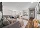 Spacious living room has ample seating and lots of natural light and view of bedroom and hall at 7702 Fairfax Dr, Kissimmee, FL 34747