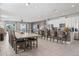 Open living space with dining table, breakfast bar, tile floors, and easy access to kitchen and living room at 7702 Fairfax Dr, Kissimmee, FL 34747