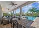 Covered outdoor patio with dining and seating areas overlooking the pool at 7702 Fairfax Dr, Kissimmee, FL 34747